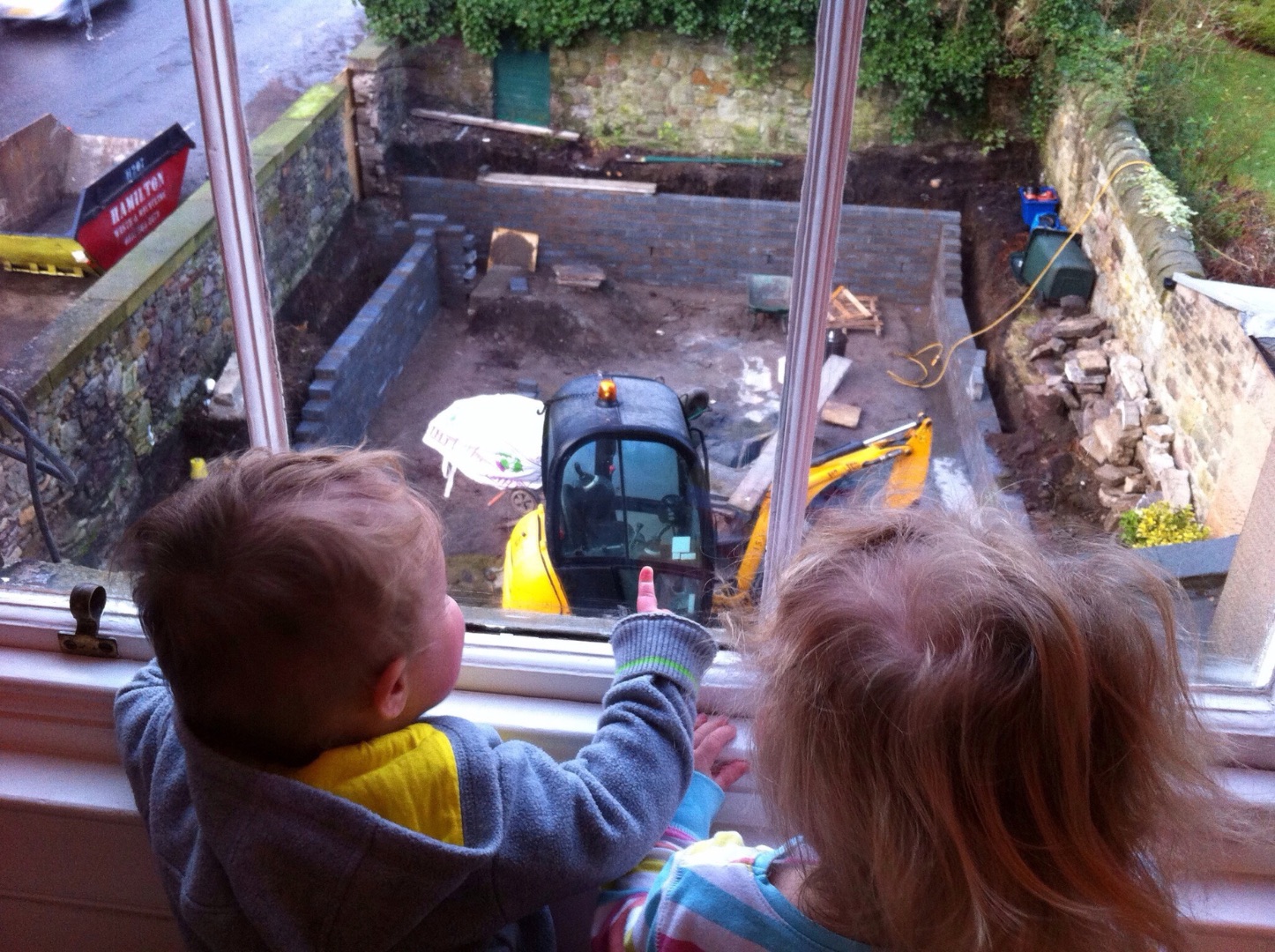 The children watching the excavations from the window above, 2012