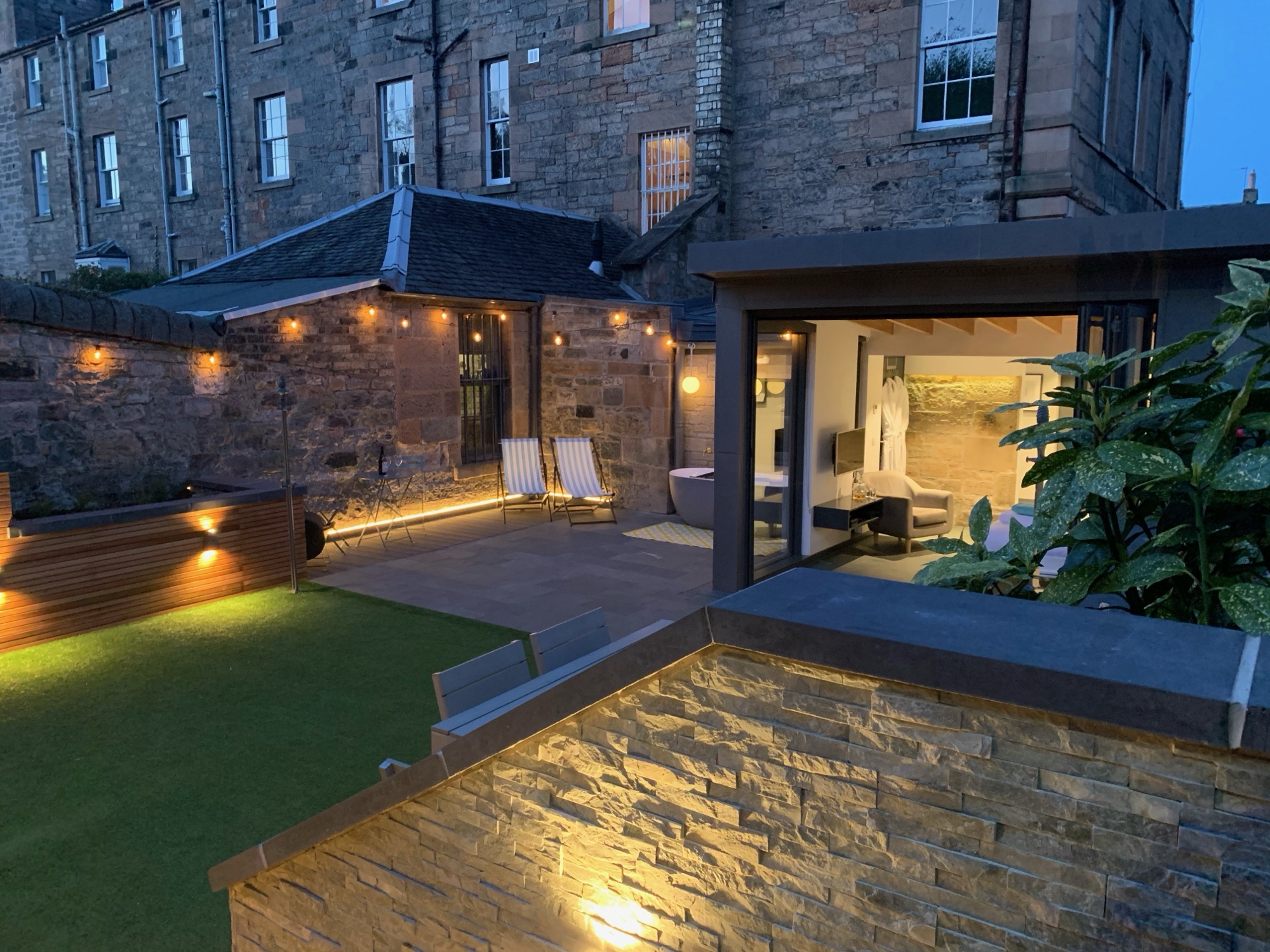 Private entrance gate lit at night