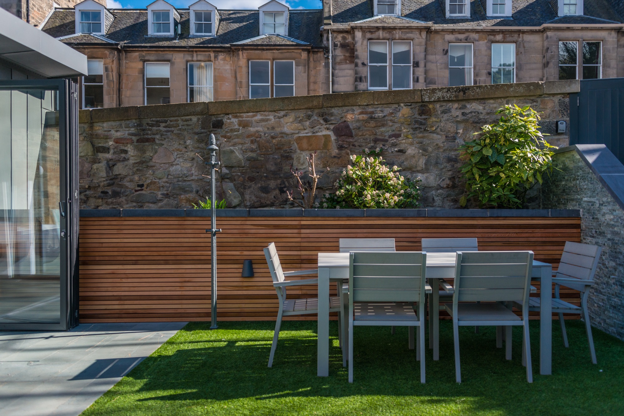 Garden dining table with cedar decking and wine