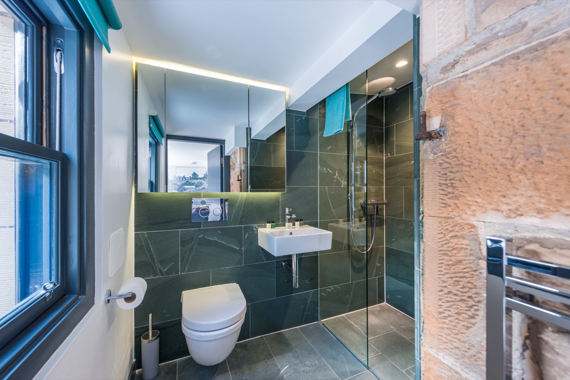 Walk-in shower room with green tiles